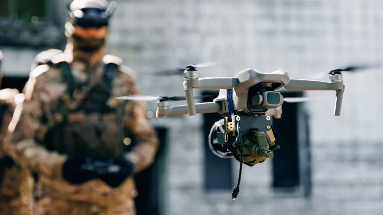 A field operator with a drone in the foreground